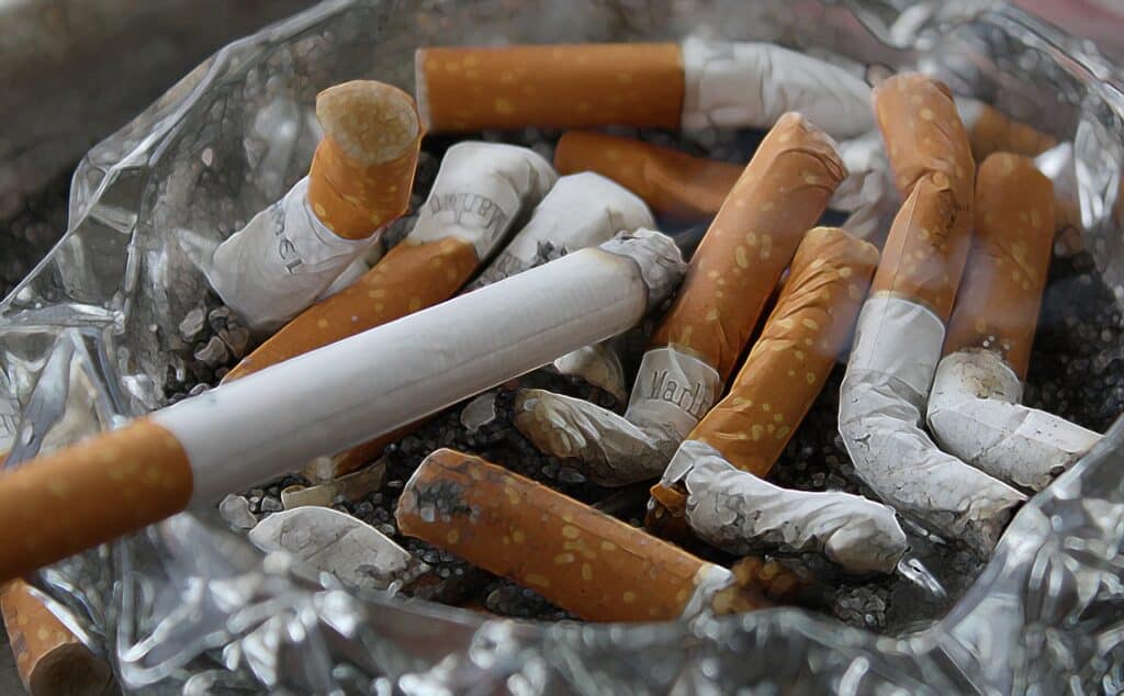 smoking damages your eyes. cigarettes in an ashtray